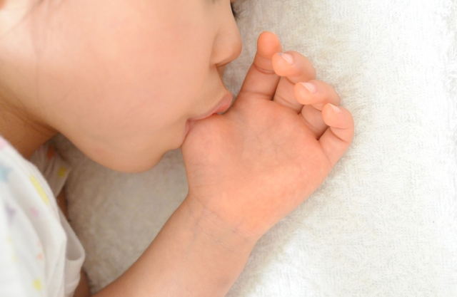 指しゃぶりをする子どもの口元
